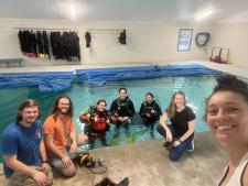 Group of people in and around an indoor pool
